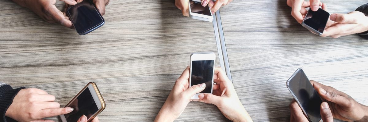 Group of friends using smartphone - People hands view having fun with mobile phones - Technology trends, and social networks app concept - Main focus on left bottom hands cellphones